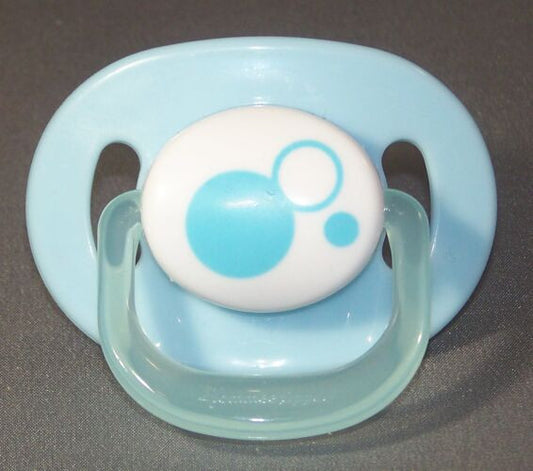 blue & decorated white dummy with Nuk teat